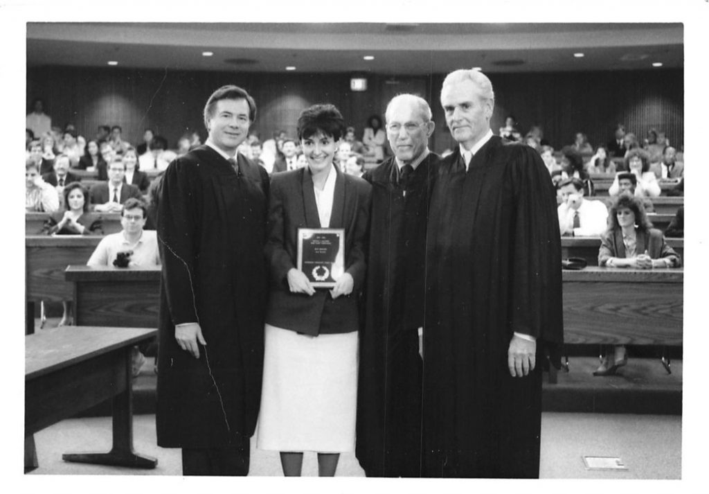 Suzanne being presented an award by Former Associate Justice of the Supreme Court of the United States, Byron White